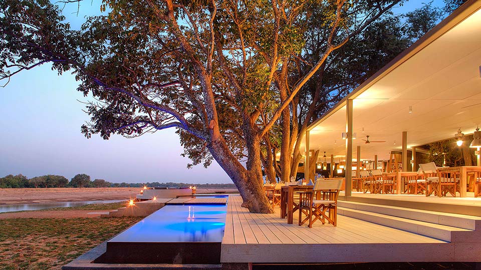 Pool deck with a view at Time + Tide Chinzombo, South Luangwa, Zambia